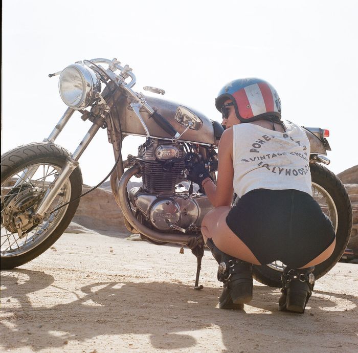 A playful frame from Girls on a motorcycle — online in Lagos